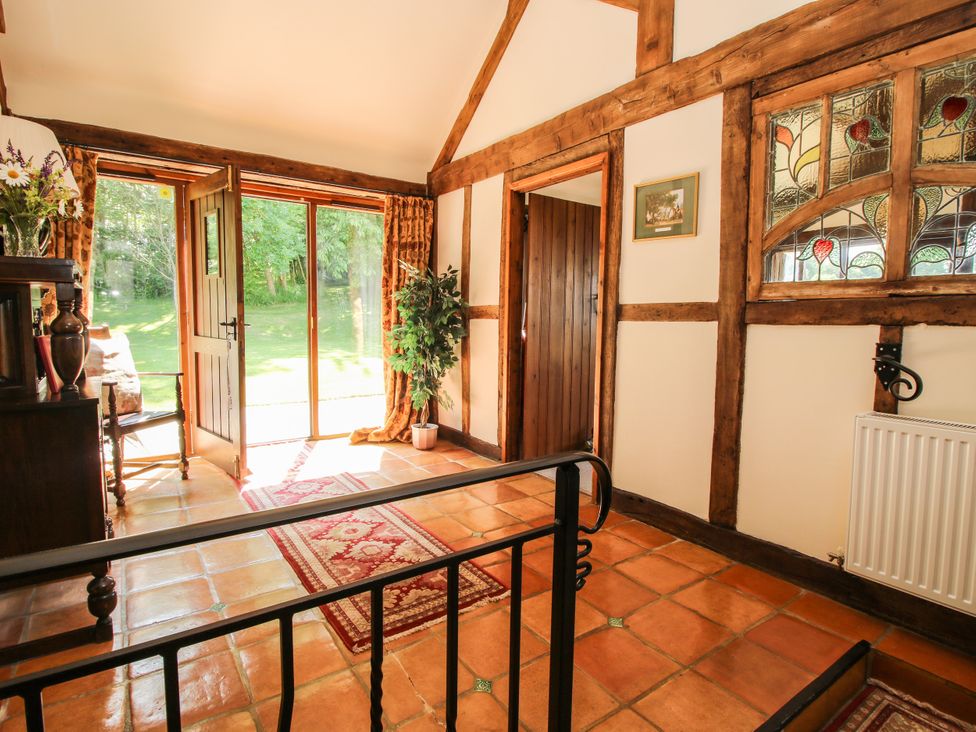 An entrance hall with doors and a rug at Corn House in Cardington