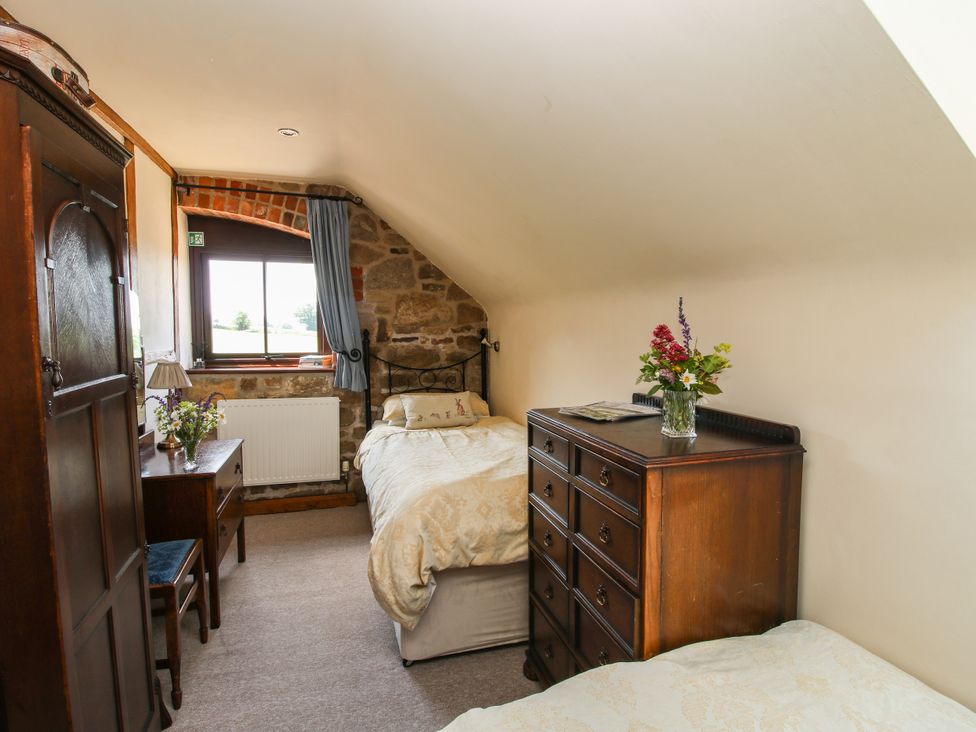 A bedroom with two beds and a window at Corn House in Cardington