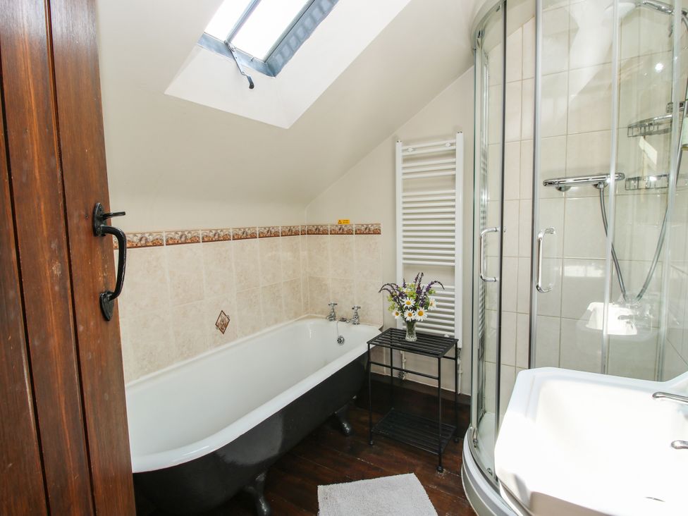 A bathroom with a bathtub and shower at Corn House in Cardington