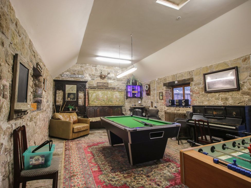 A game room featuring a pool table and foosball table at Corn House in Cardington