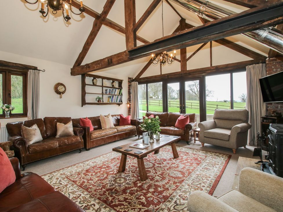 A living room with sofas and a coffee table at Corn House in Cardington