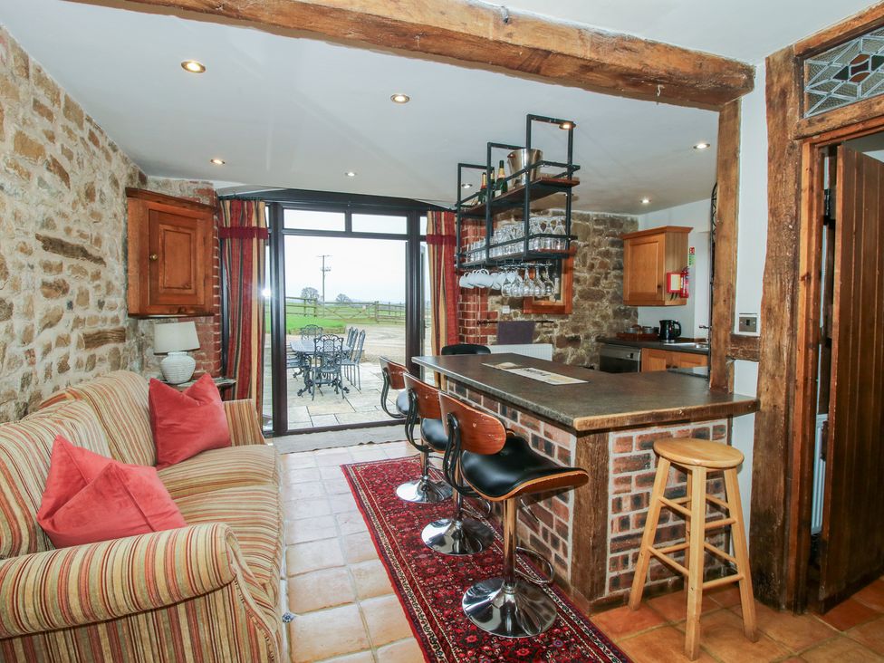 A kitchen with seating area and dining table at Corn House in Cardington