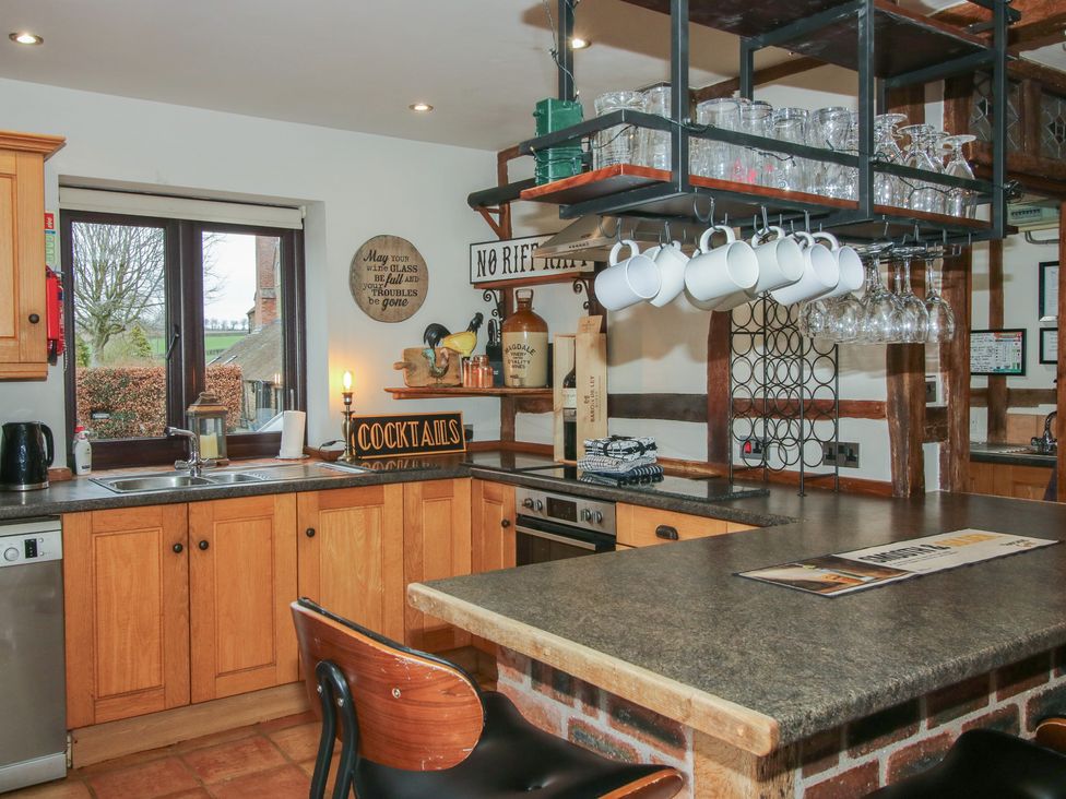 A kitchen with cabinets and countertop at Corn House in Cardington