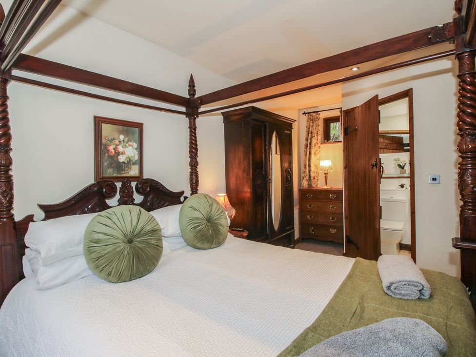 A bedroom with a bed and wardrobe at Corn House in Cardington