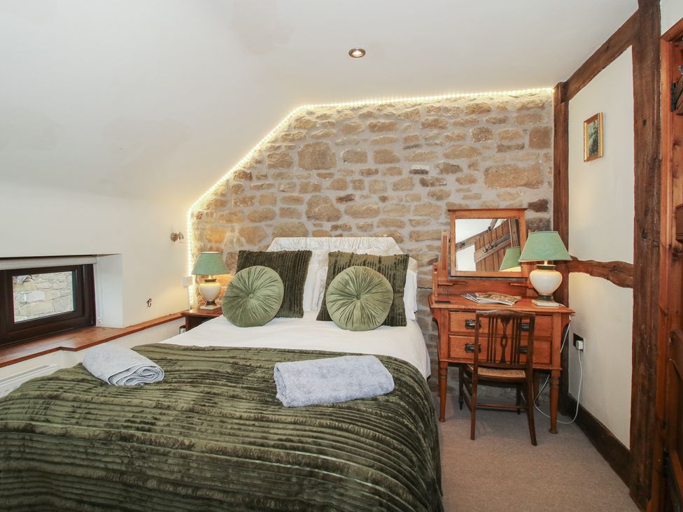 A bedroom with a bed and a dresser at Corn House in Cardington