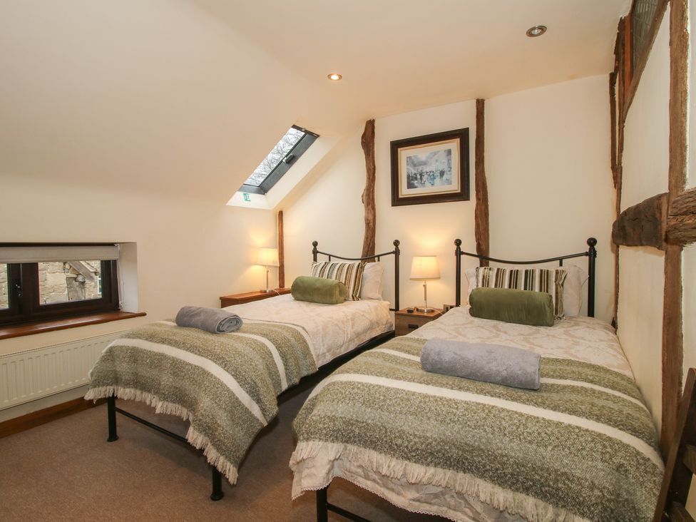 A bedroom with twin beds and a window at Corn House in Cardington
