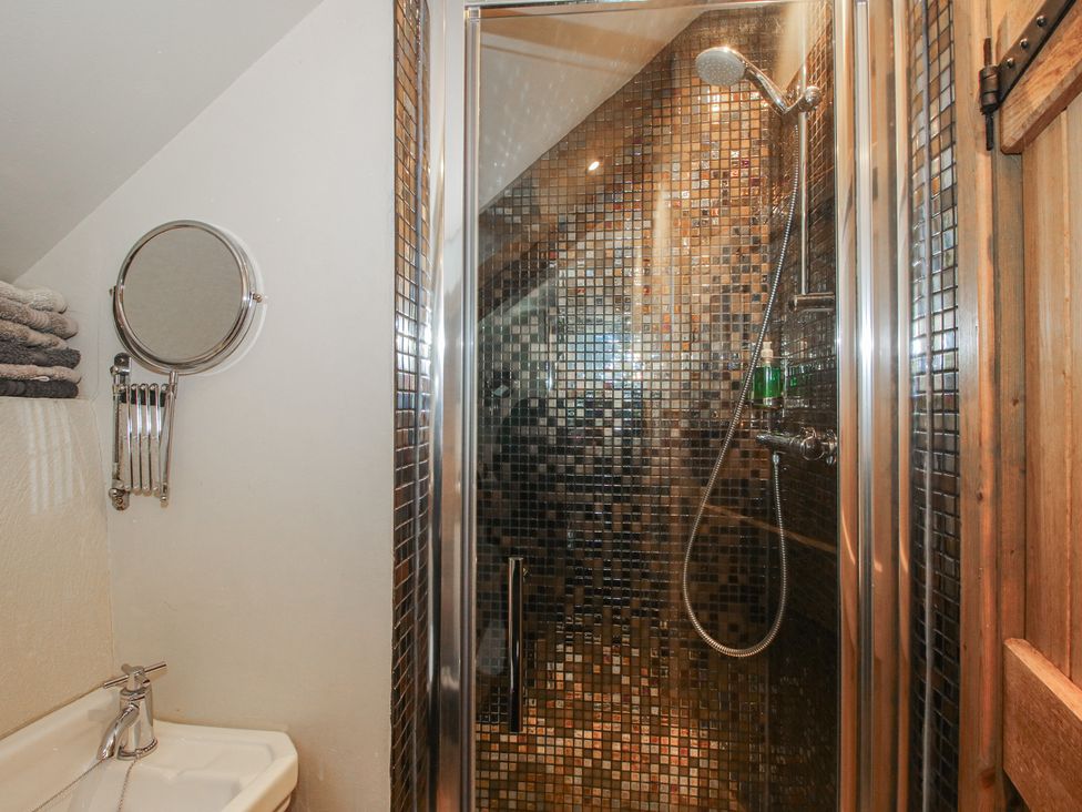 A bathroom with a shower and sink at Corn House in Cardington
