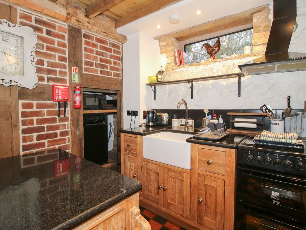 A kitchen with a sink and oven at Corn House in Cardington