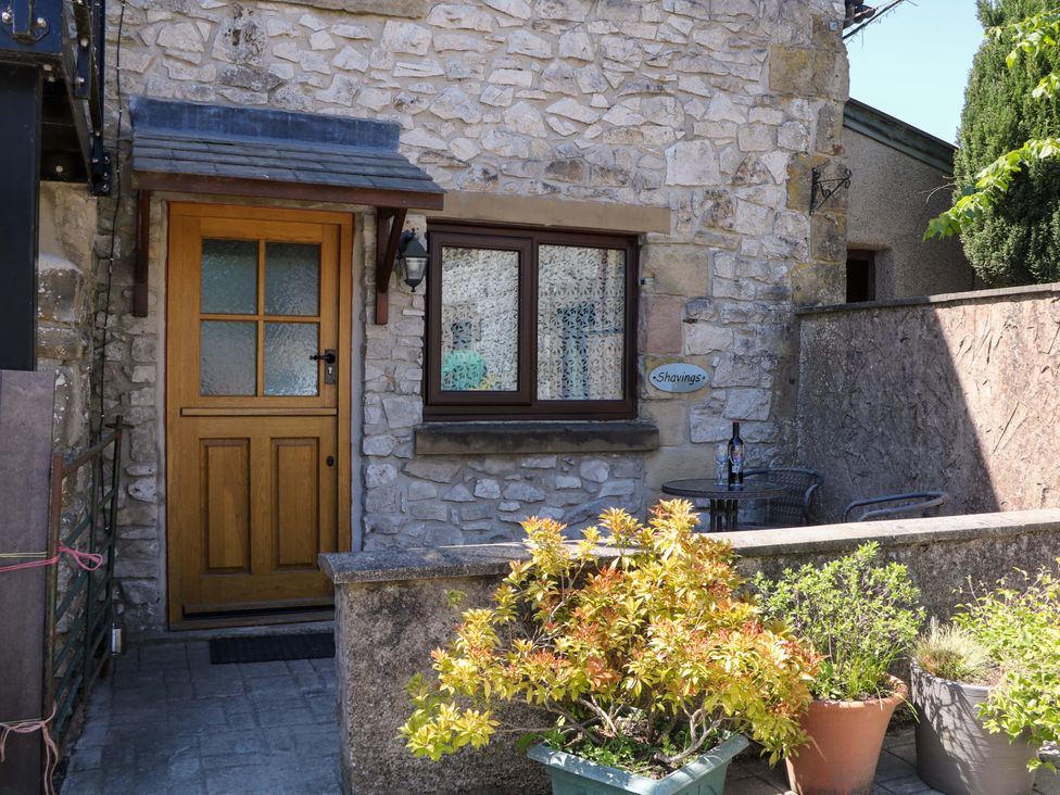 An outdoor area with a door and window at The Shavings in Cowdale near Buxton