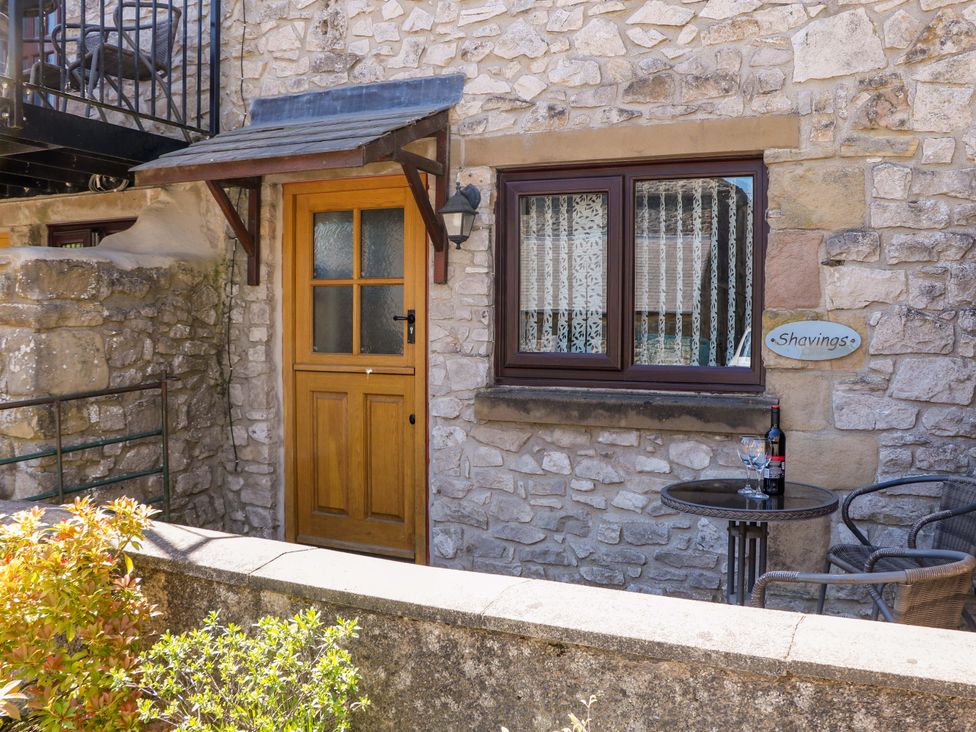 An outdoor area with a door and table at The Shavings in Cowdale near Buxton