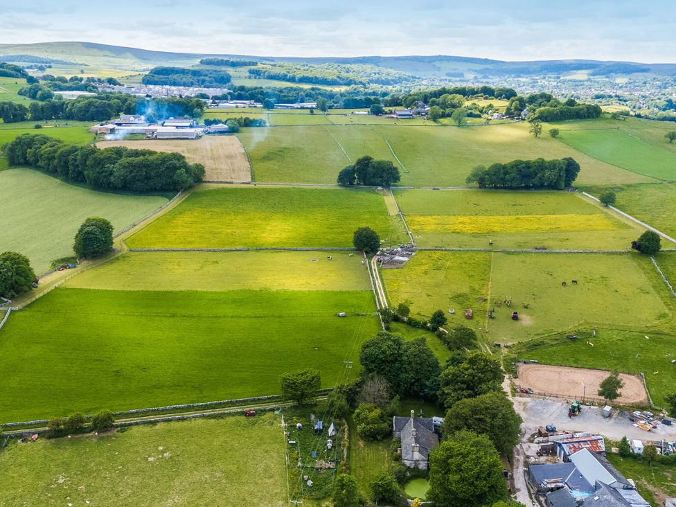 An aerial view of fields and farm buildings at Woodlands in Cowdale near Buxton