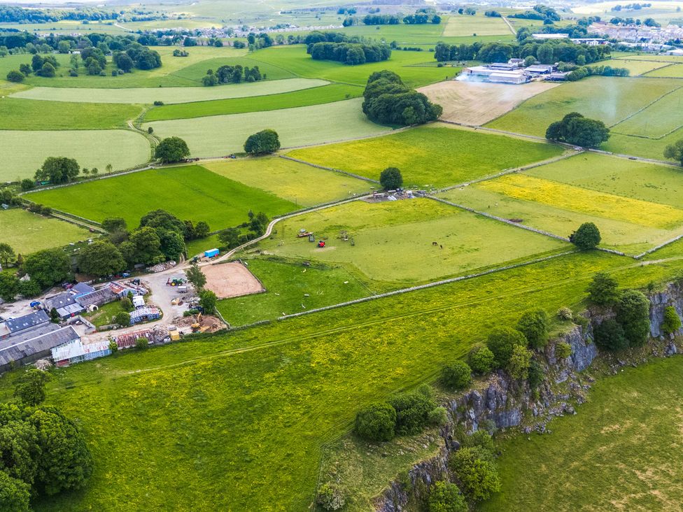 An aerial view of fields and farm buildings at Woodlands in Cowdale near Buxton