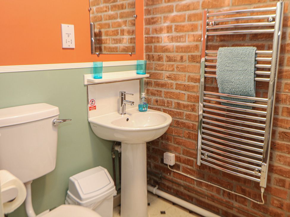 A bathroom with a sink and toilet at Woodlands in Cowdale near Buxton