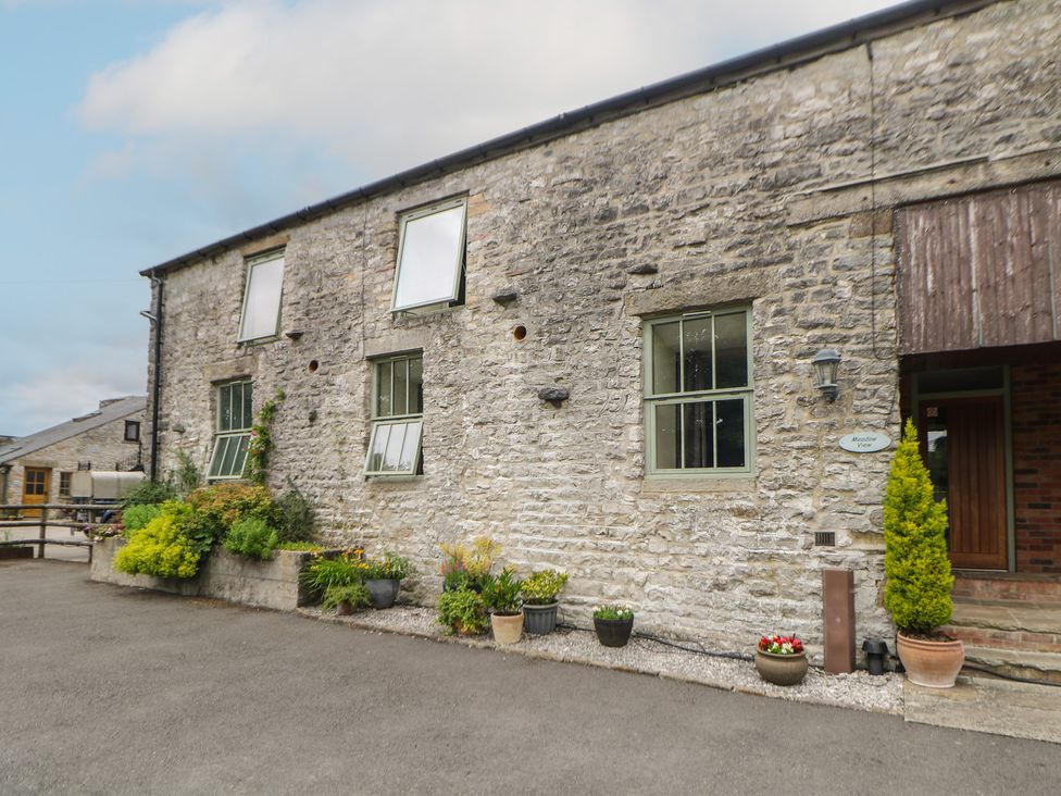 A building exterior with windows and plants at Meadow View in Buxton