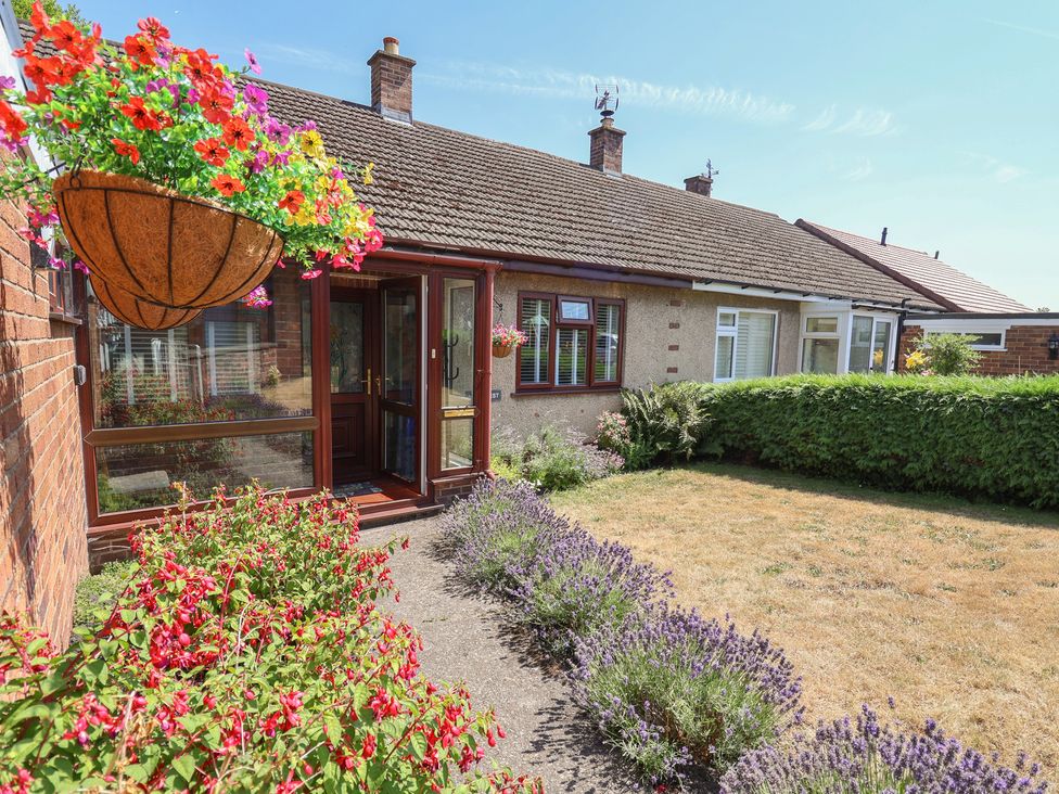 A garden with flowers and a door at Hillcrest in Cefn Mawr near Chirk