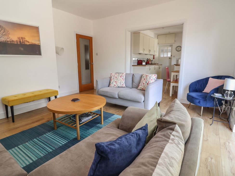 A living room with a sofa and coffee table at Hillcrest in Cefn Mawr near Chirk