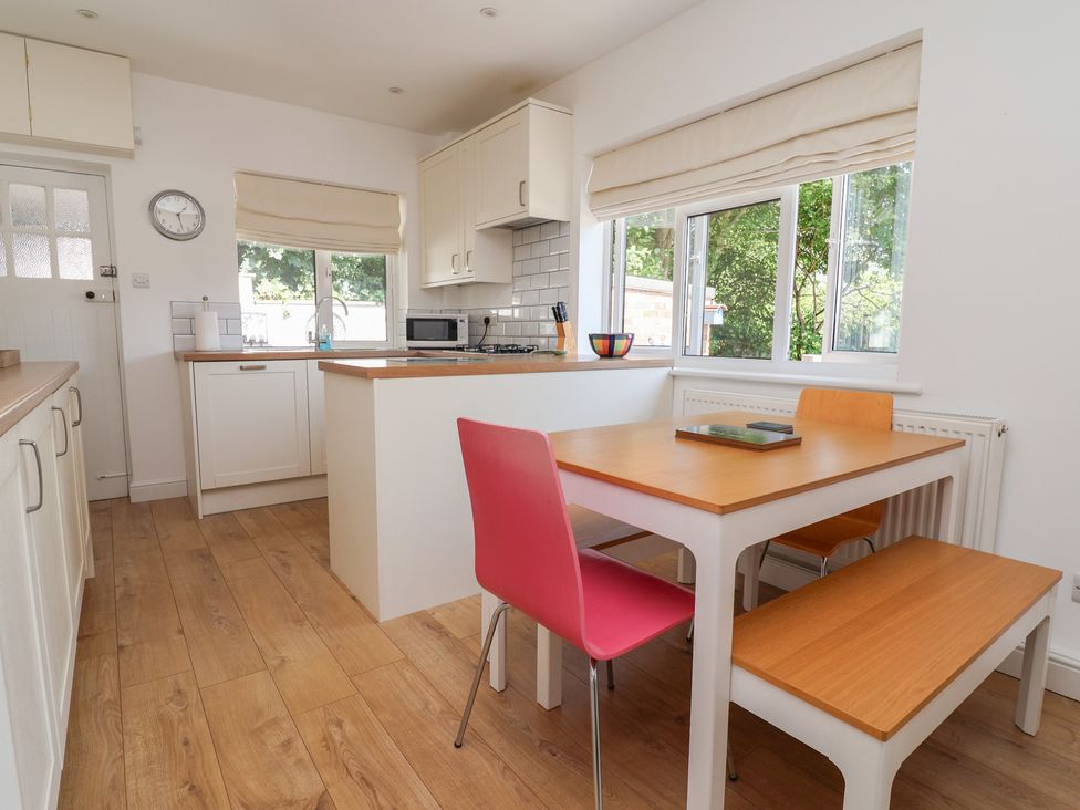 A kitchen with a table and chairs at Hillcrest in Cefn Mawr near Chirk