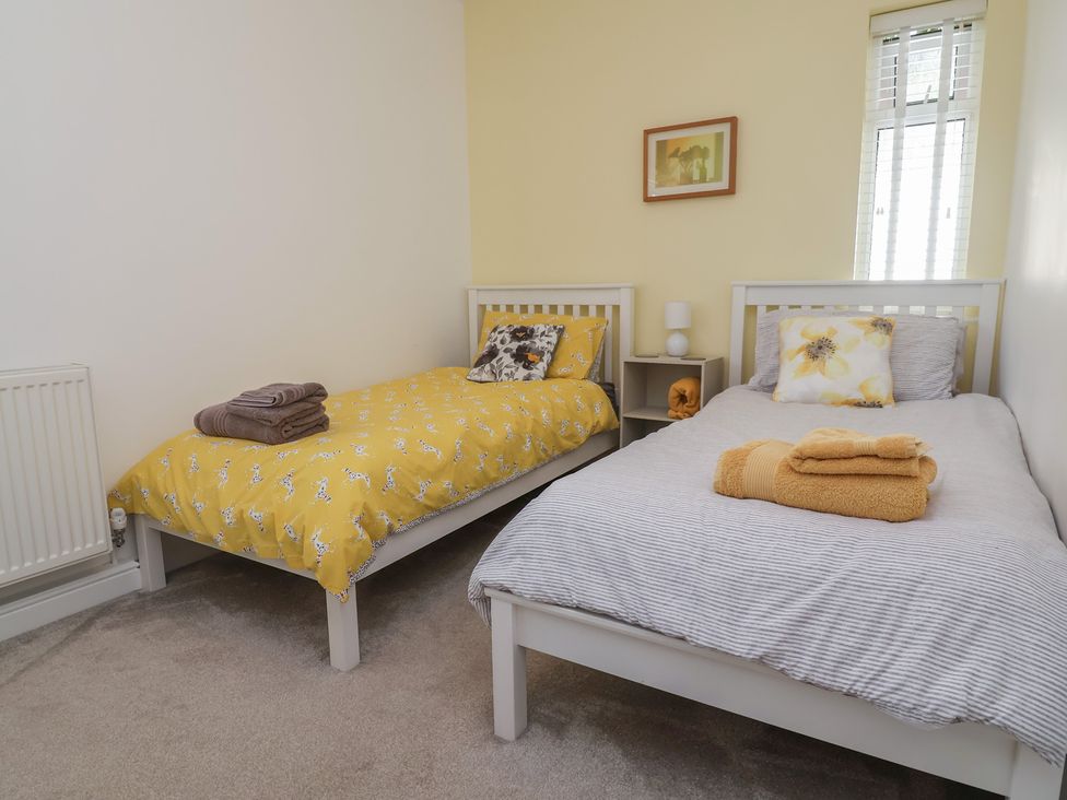 A bedroom with two single beds and a nightstand at Hillcrest in Cefn Mawr near Chirk