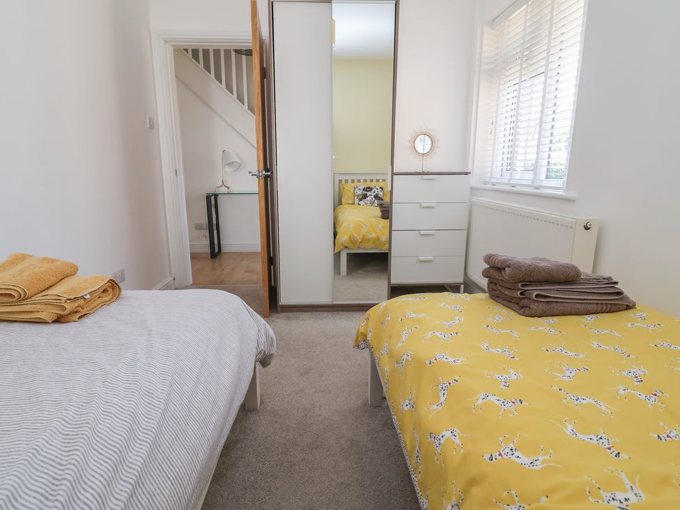 A bedroom with two beds and storage at Hillcrest in Cefn Mawr near Chirk