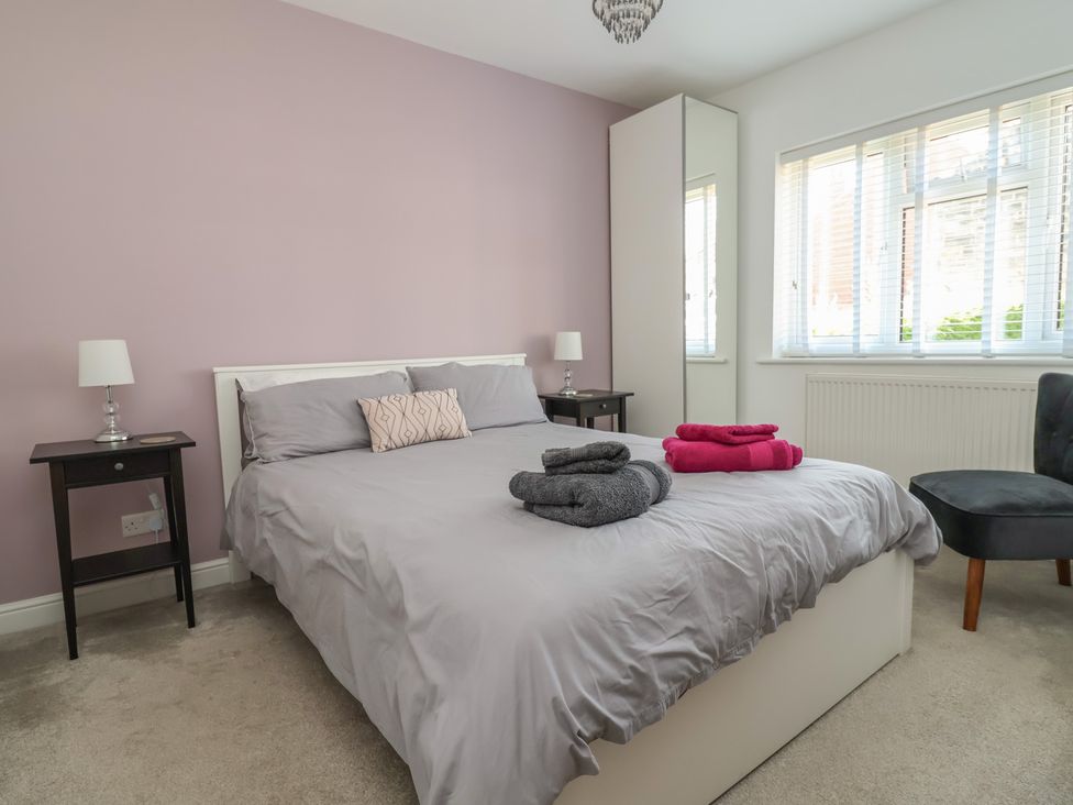 A bedroom with a bed and nightstands at Hillcrest in Cefn Mawr near Chirk