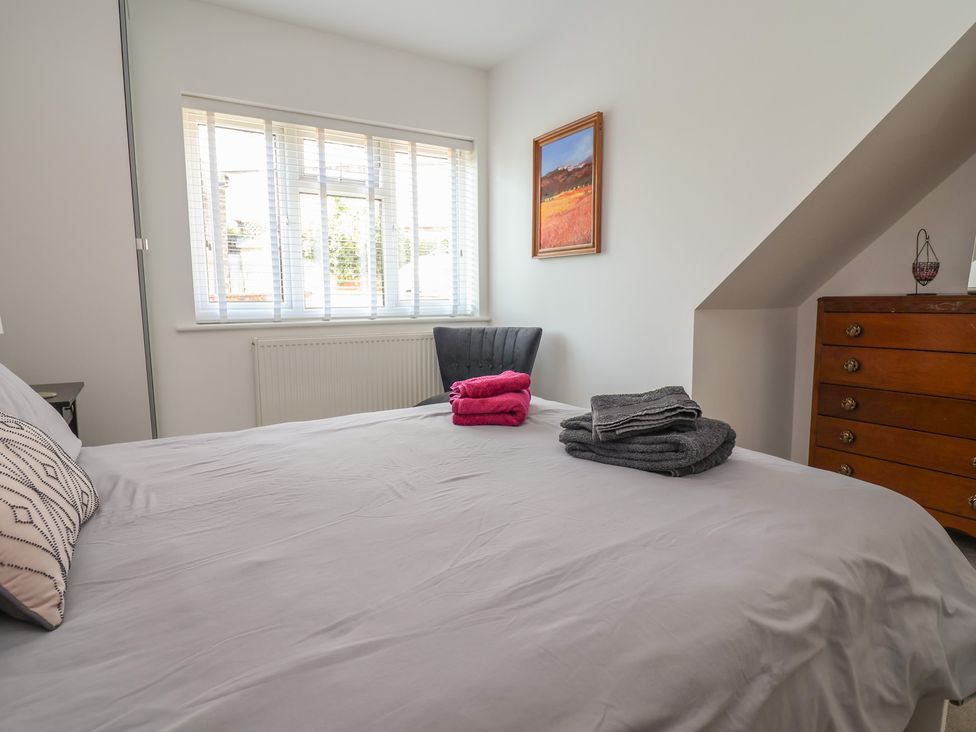 A bedroom with a bed and chair at Hillcrest in Cefn Mawr near Chirk