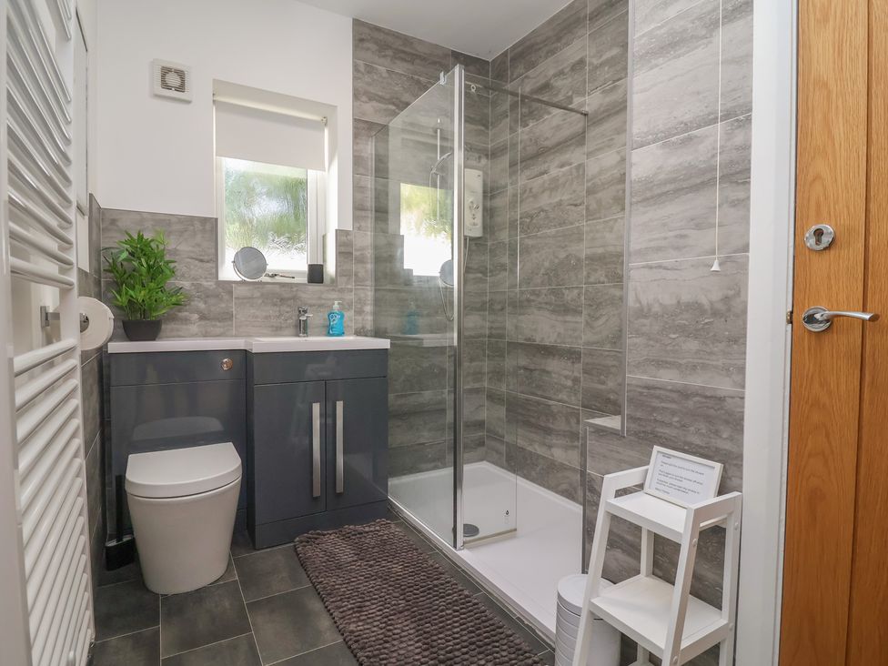 A bathroom with a shower and a sink at Hillcrest in Cefn Mawr near Chirk