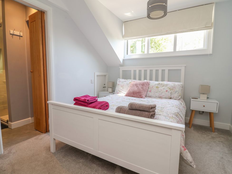 A bedroom with a bed and nightstand at Hillcrest in Cefn Mawr near Chirk