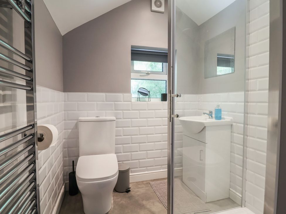 A bathroom with a toilet, sink and shower at Hillcrest in Cefn Mawr near Chirk