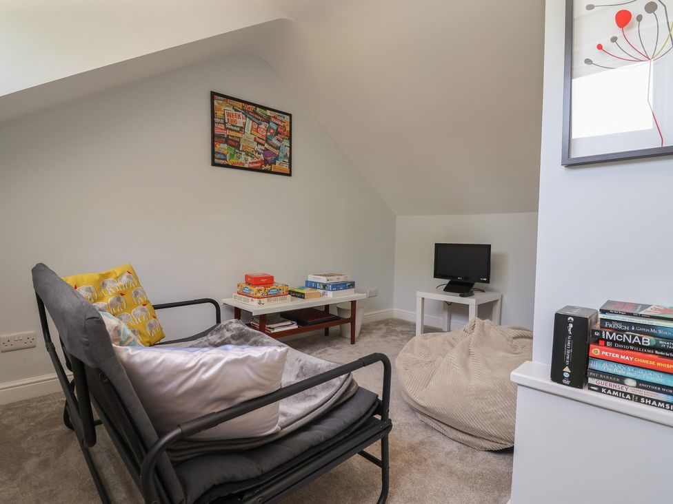 A snug with a sofa and board games at Hillcrest in Cefn Mawr near Chirk