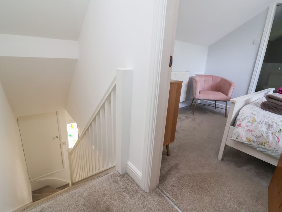 A bedroom with a chair and bed at Hillcrest in Cefn Mawr near Chirk
