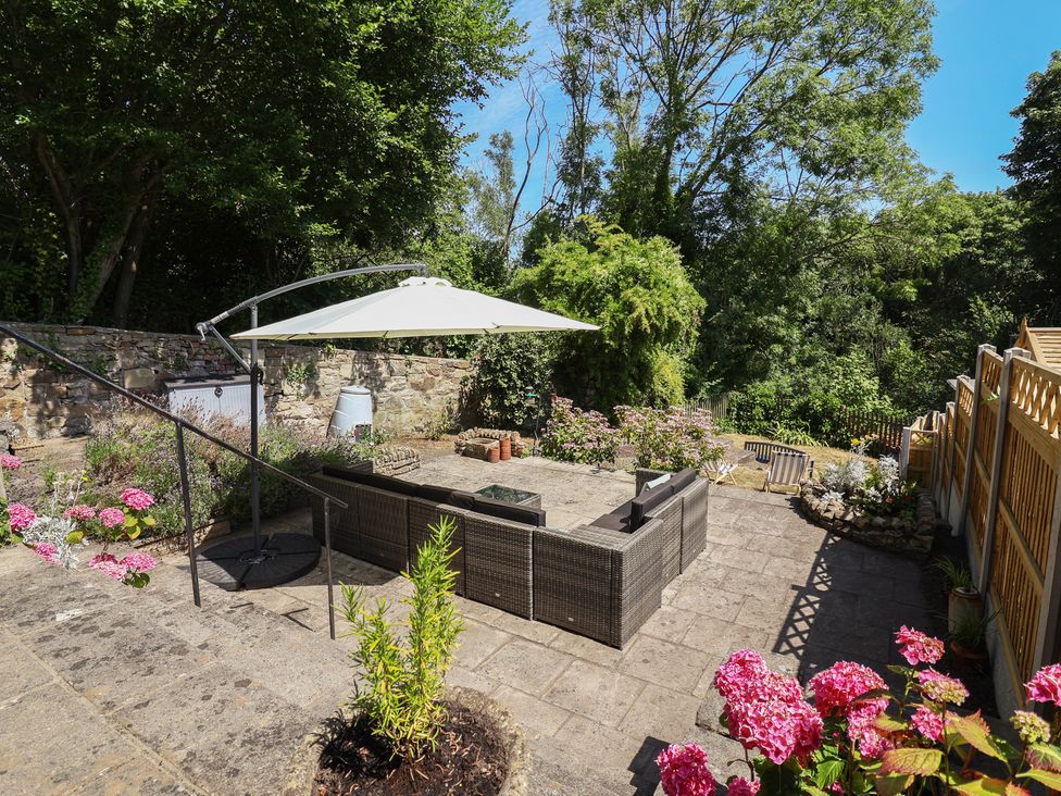 A garden area with seating and flowers at Hillcrest in Cefn Mawr near Chirk