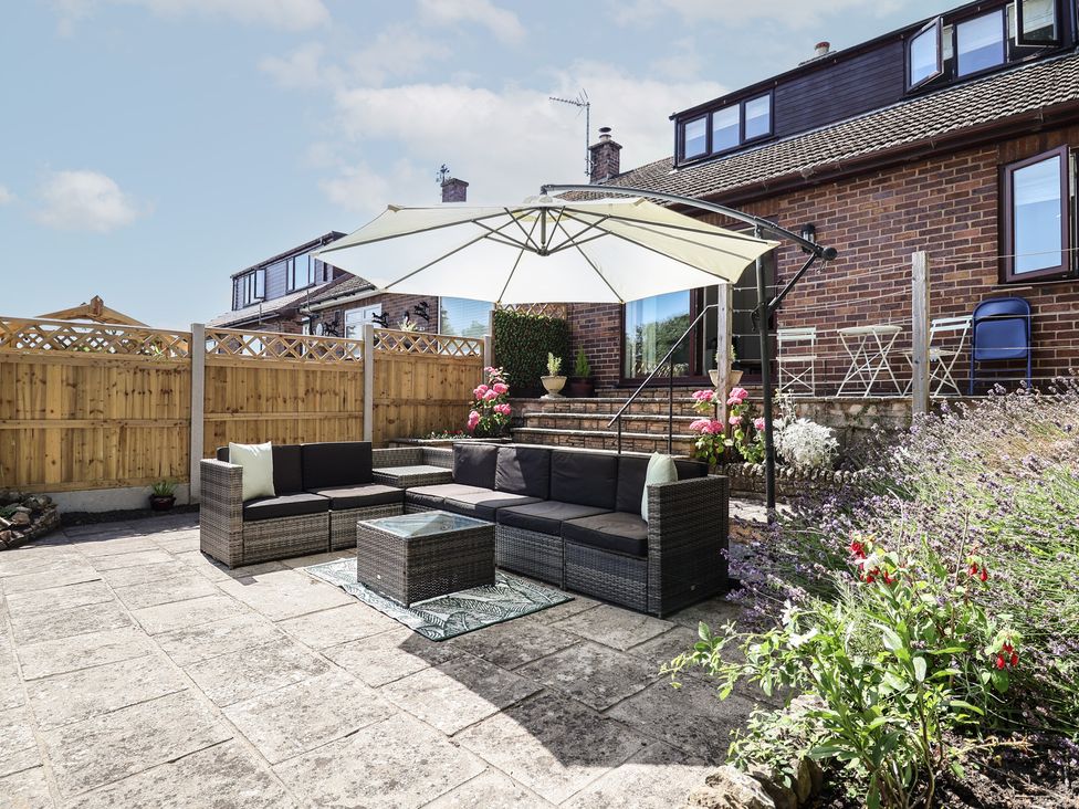 A garden with seating area and plants at Hillcrest in Cefn Mawr near Chirk