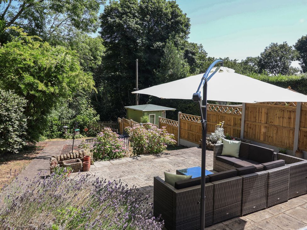 A garden with a seating area and flowers at Hillcrest in Cefn Mawr near Chirk