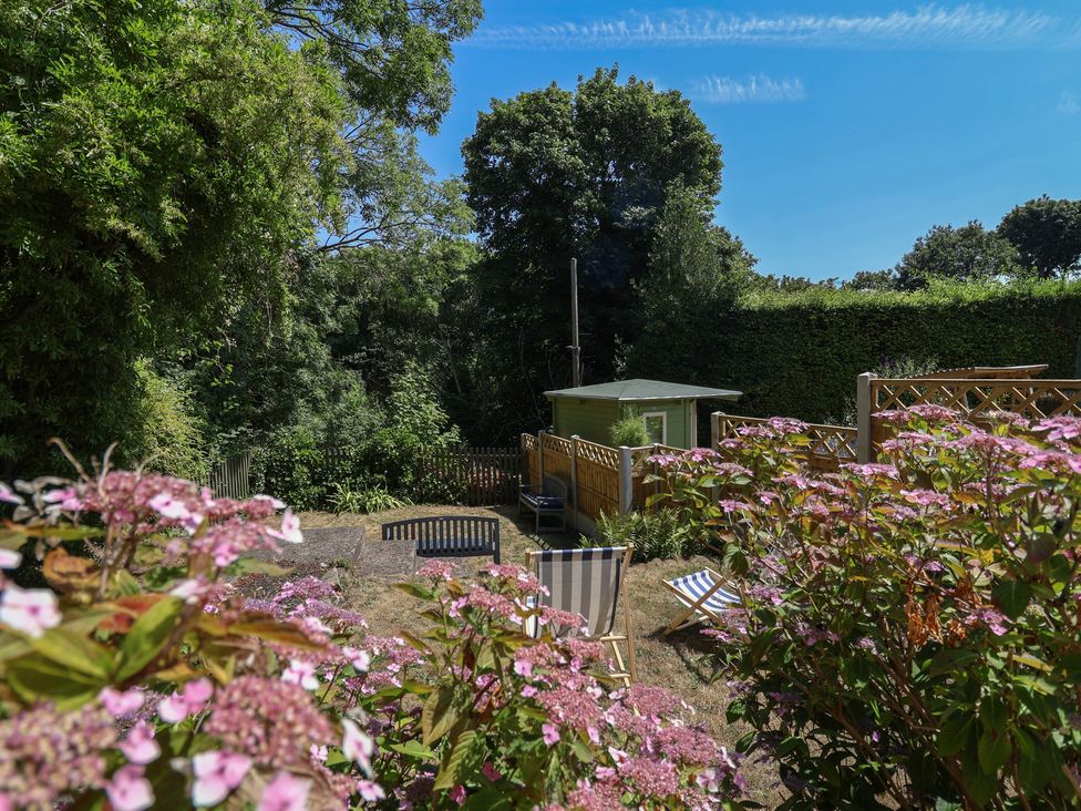 A garden with flowers and a shed at Hillcrest in Cefn Mawr near Chirk
