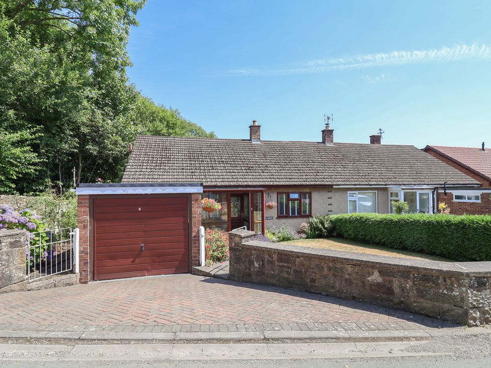 A house with a garage and pathway at Hillcrest in Cefn Mawr near Chirk