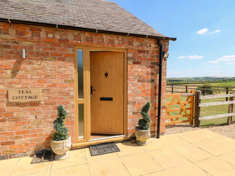 An entrance with a front door and garden features at Teal Cottage in Melton Mowbray