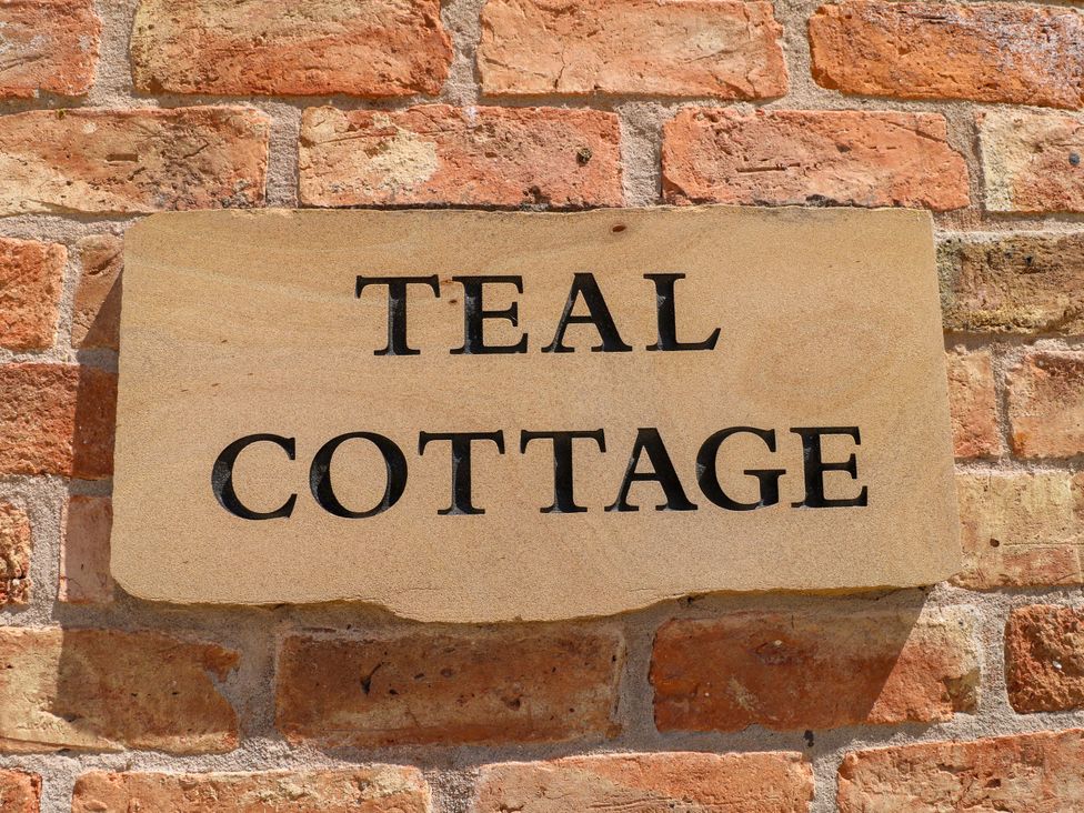 A sign on a brick wall at Teal Cottage Melton Mowbray