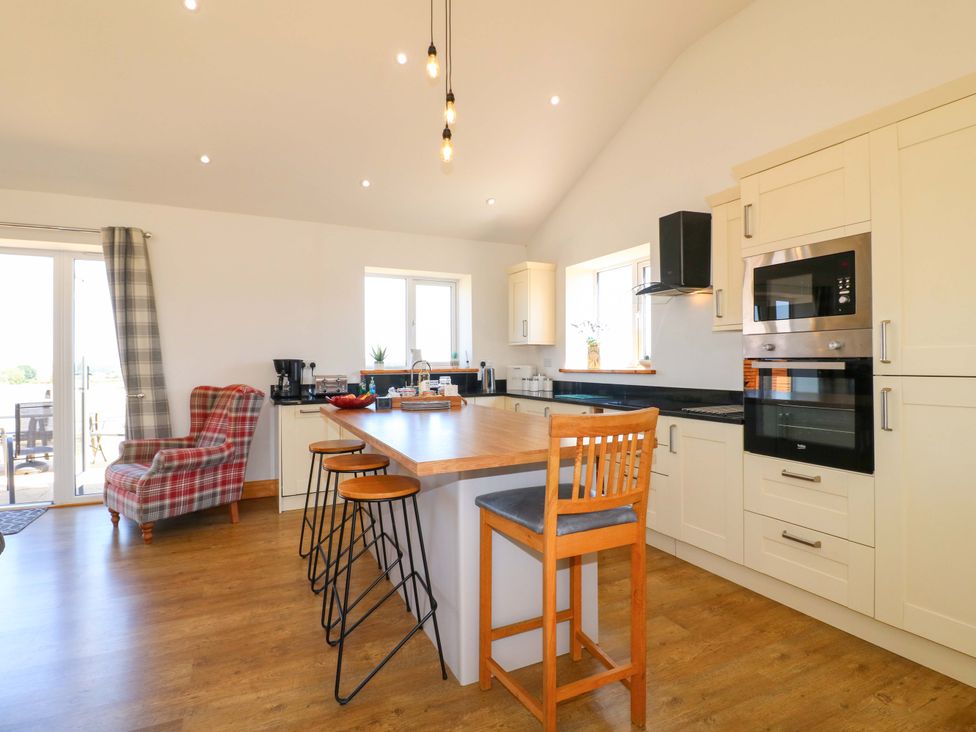 A kitchen with countertops and appliances at Teal Cottage Melton Mowbray