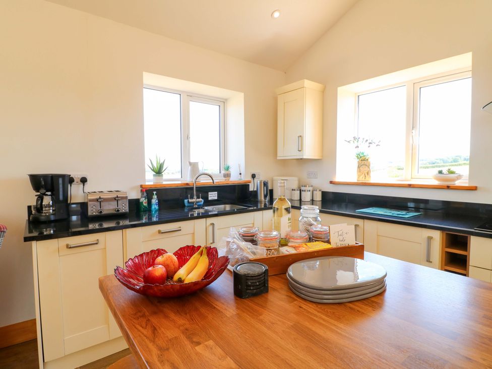 A kitchen with a sink and coffee maker at Teal Cottage Melton Mowbray