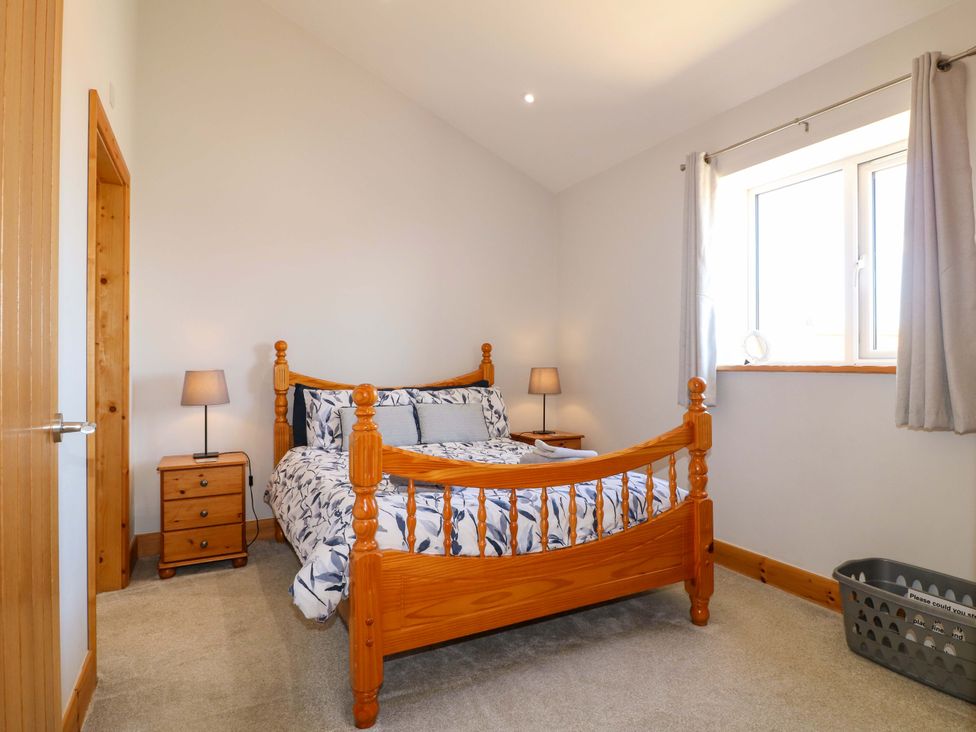 A bedroom with a bed and nightstand at Teal Cottage in Melton Mowbray
