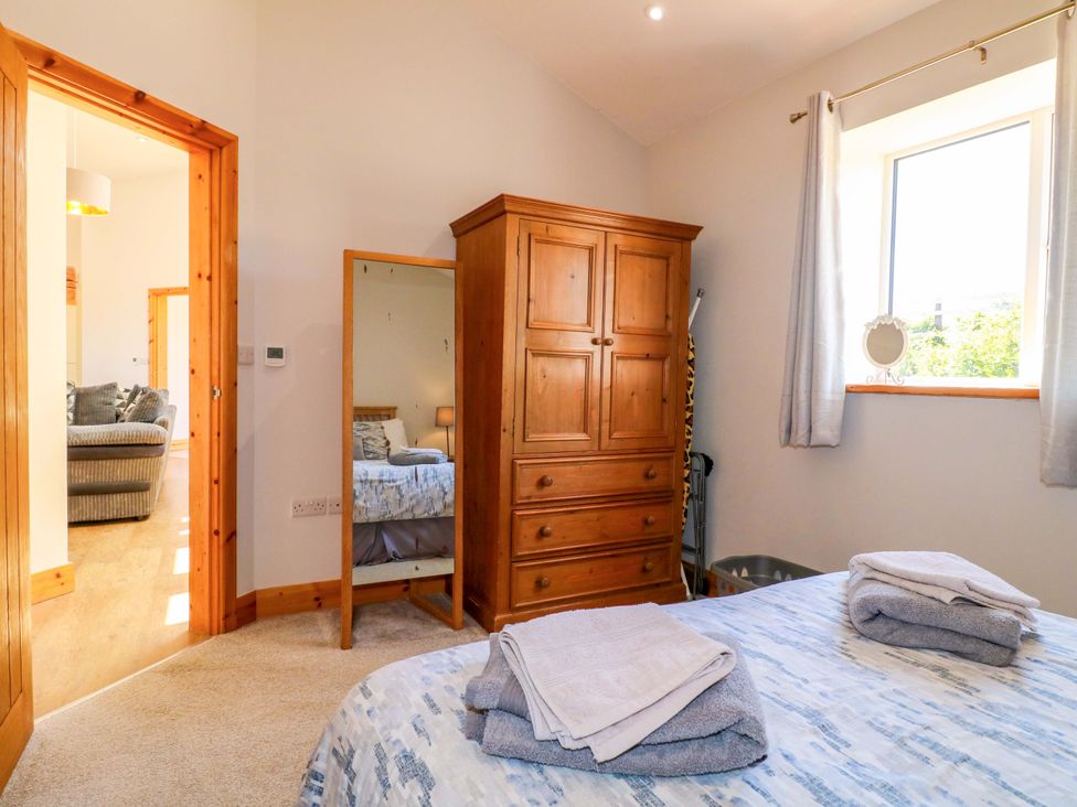 A bedroom with a bed and a chest of drawers at Teal Cottage in Melton Mowbray