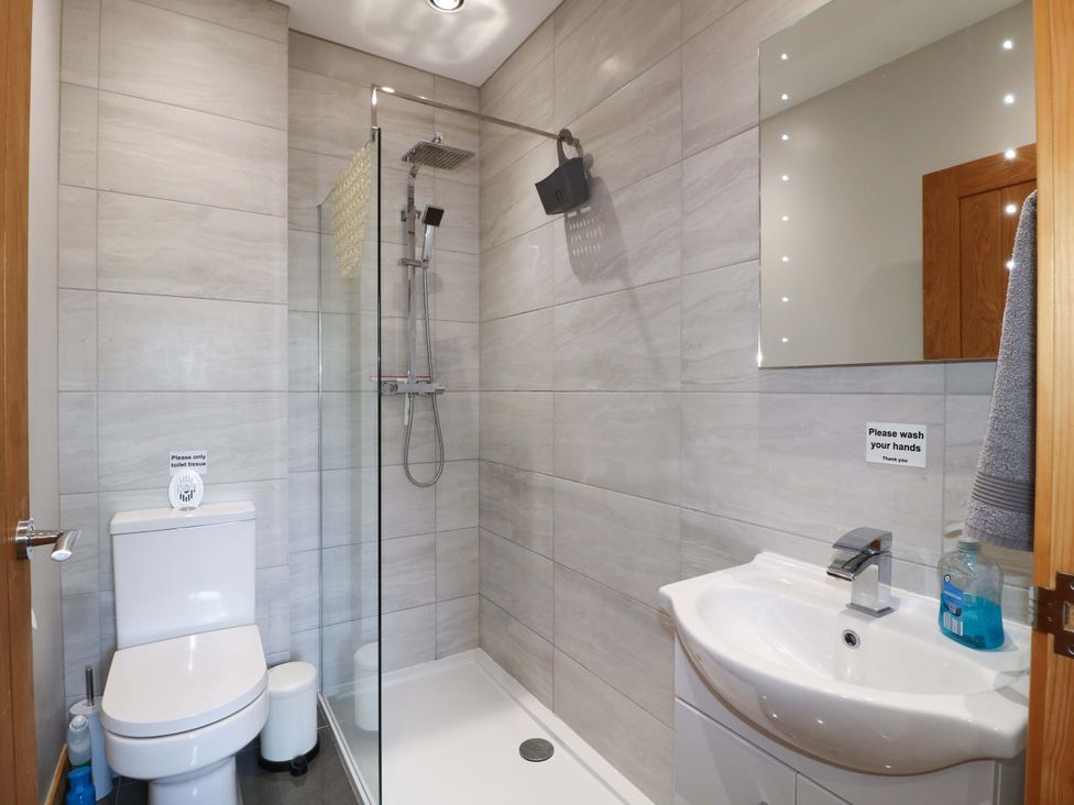 A bathroom with a shower, toilet and sink at Teal Cottage in Melton Mowbray