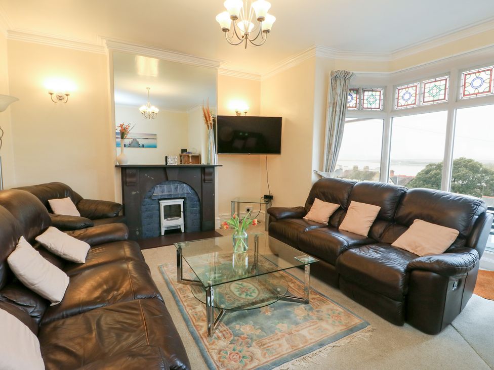 A living room with a sofa and coffee table at Preswylfa in Caernarfon