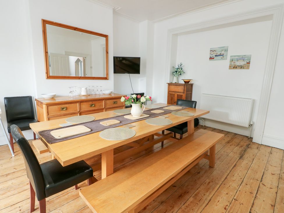 A dining room with a table and chairs at Preswylfa, Caernarfon