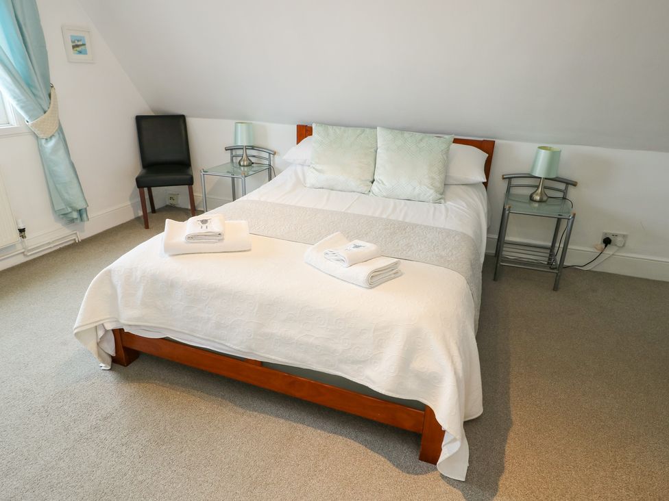 A bedroom with a bed and nightstand at Preswylfa in Caernarfon
