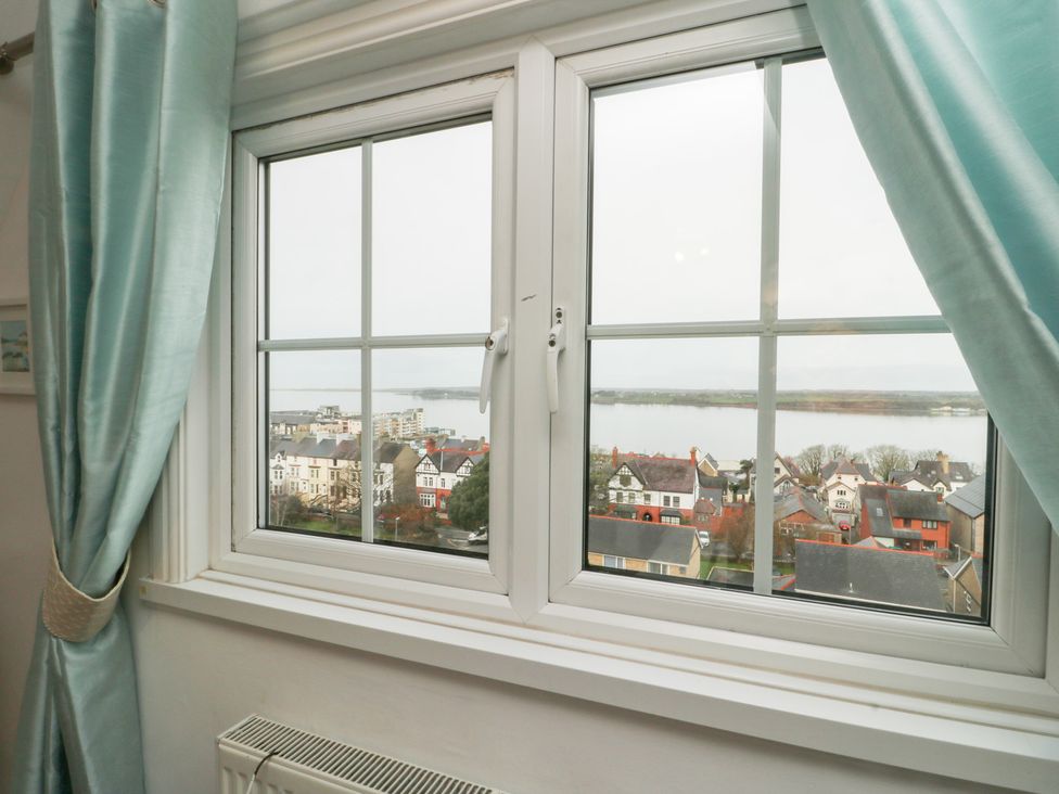 A view from a window showing buildings and water at Preswylfa, Caernarfon