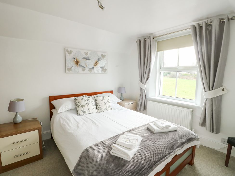 A bedroom with a bed and bedside table at Preswylfa in Caernarfon