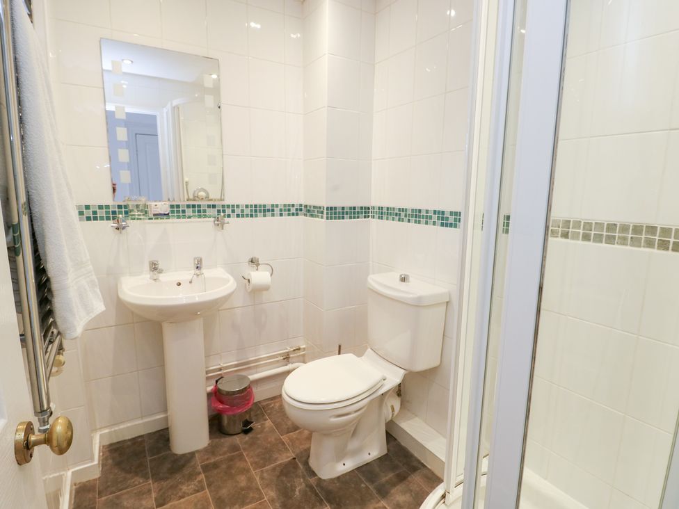A bathroom with sink and shower at Preswylfa Caernarfon