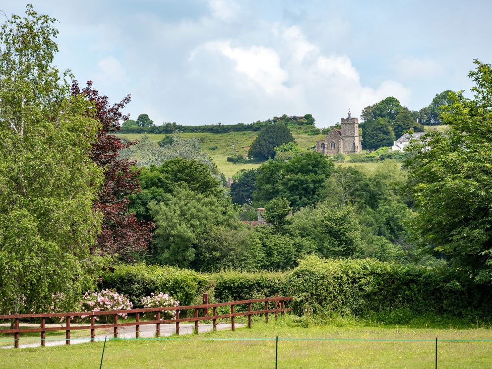 A view of a church and trees at Willow Barn in Cucklington near Wincanton