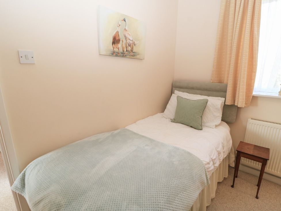 A bedroom with a bed and painting at Willow Barn in Cucklington near Wincanton